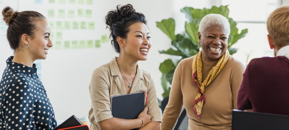 understanding social identities group of people in the workplace smiling