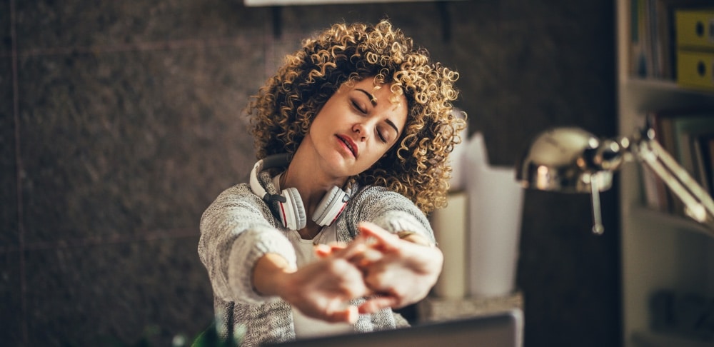 Woman stretching in the office