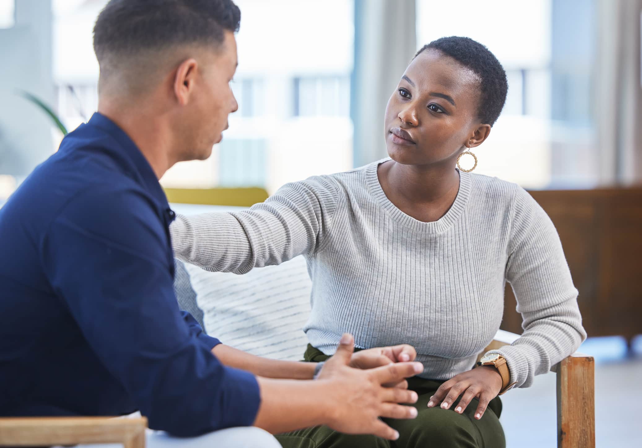 Shot of a businesswoman consoling her colleague while sitting together in an office