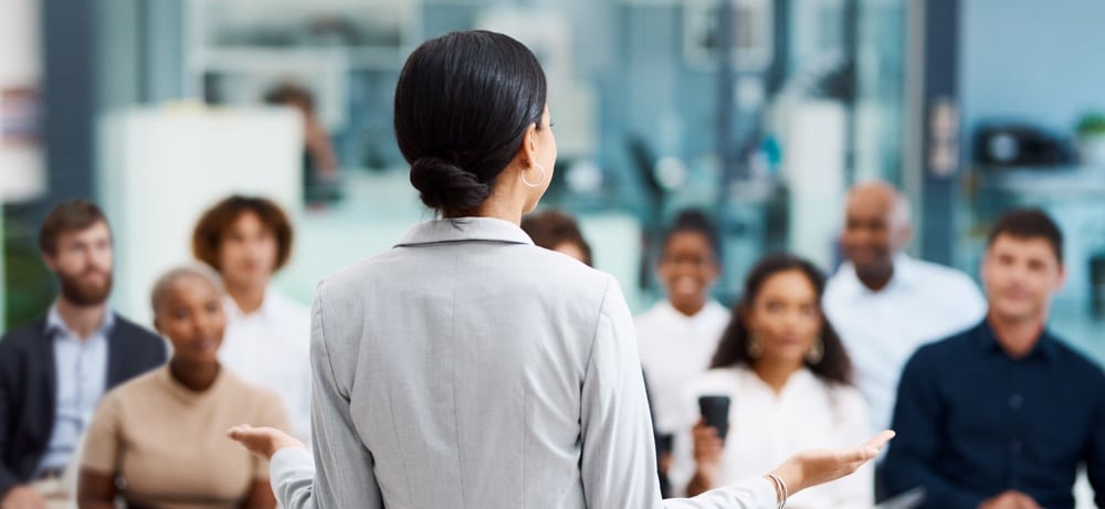 Rearview shot of an unrecognizable businesswoman giving a presentation in the office boardroom