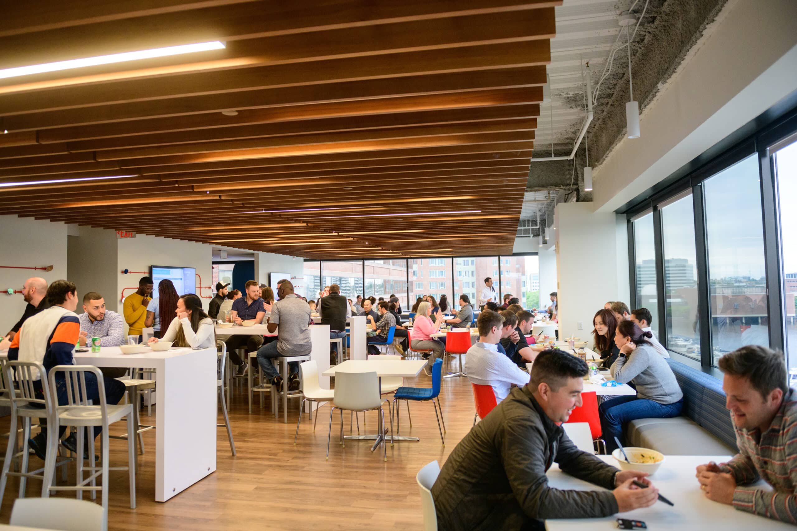 CarGurus office space filled with people chatting at different tables