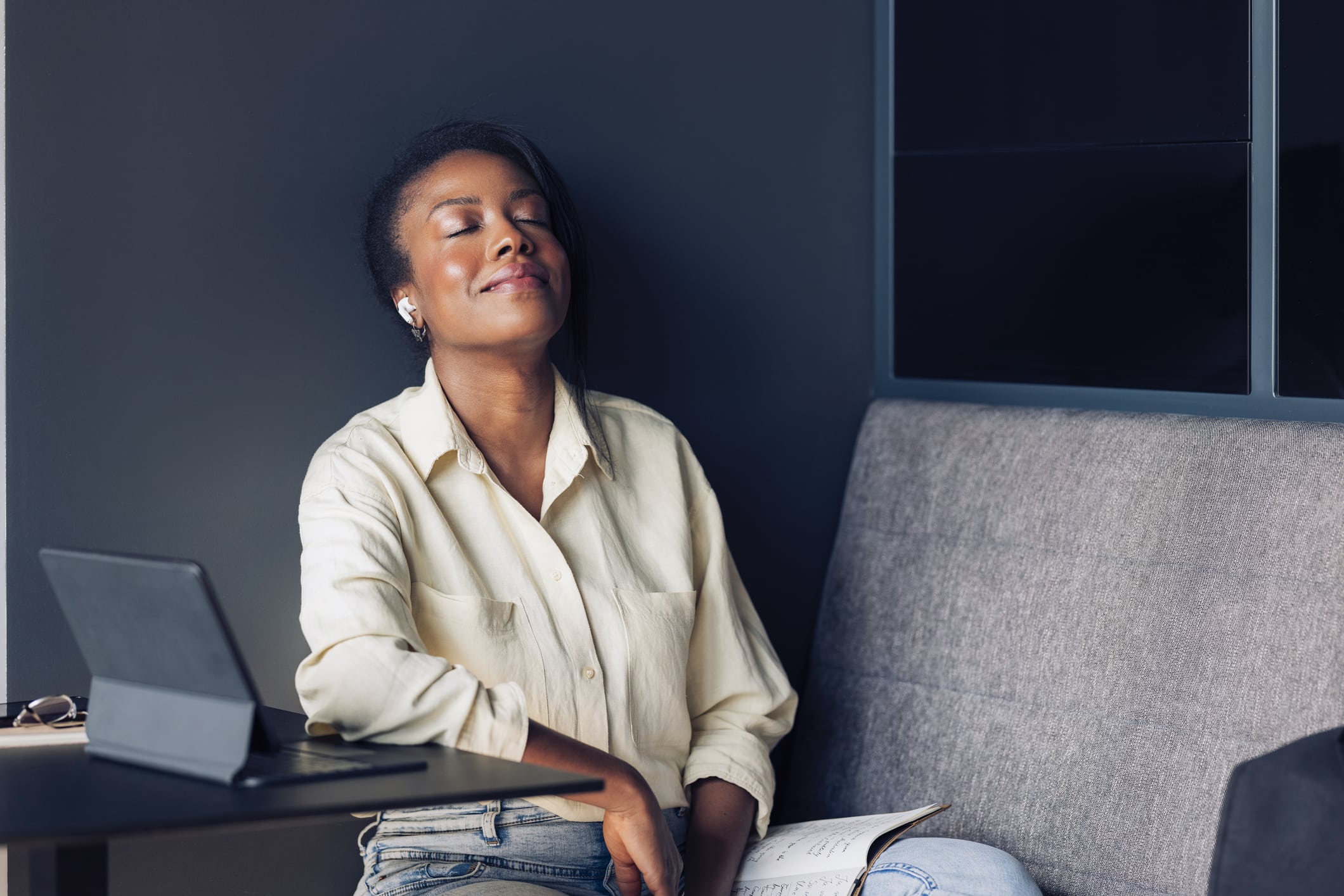 Happy African-American business woman preparing for online web conference on a digital in a cafe