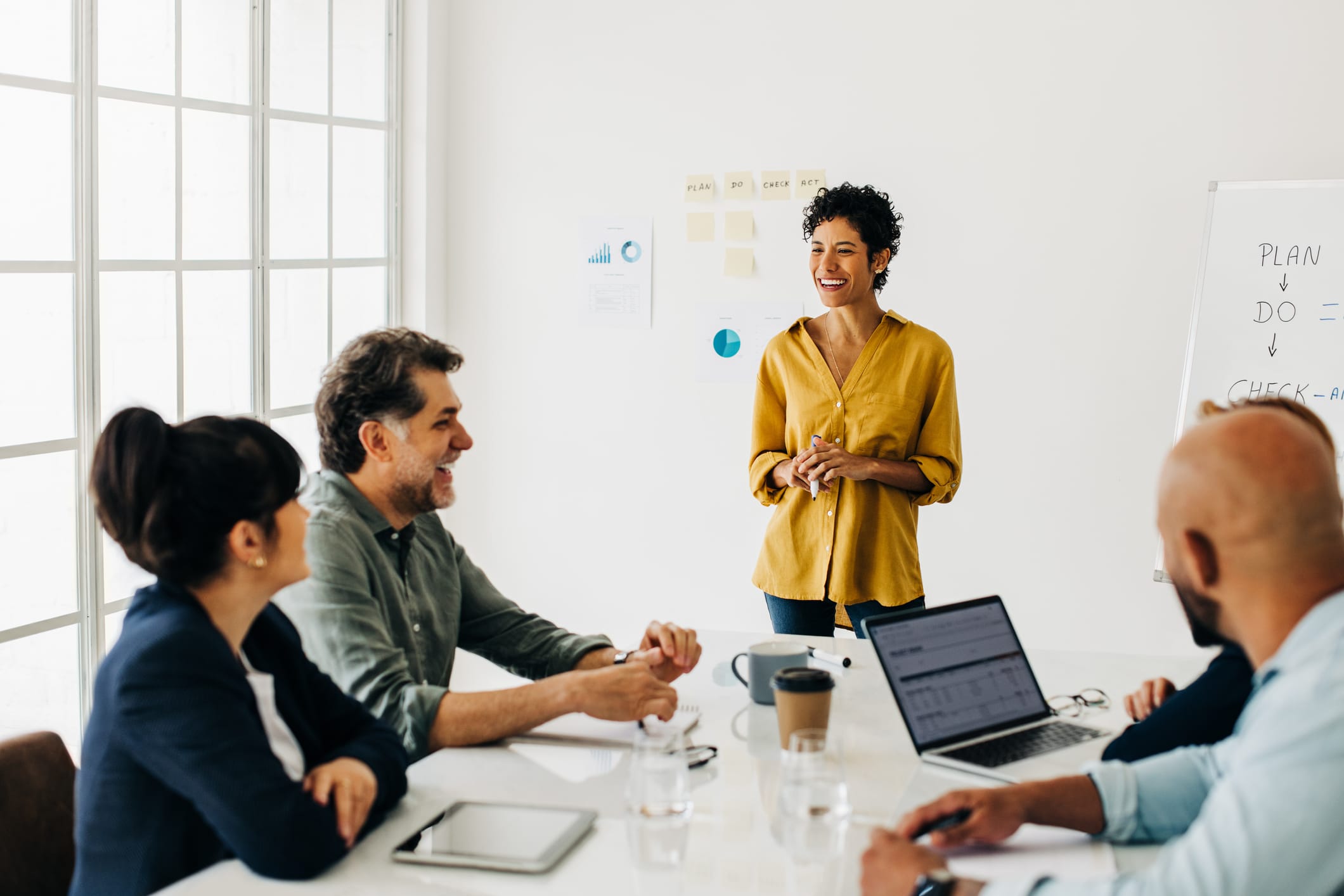 Business team having a discussion in a boardroom. Professionals work together to complete a project, sharing ideas and solutions.