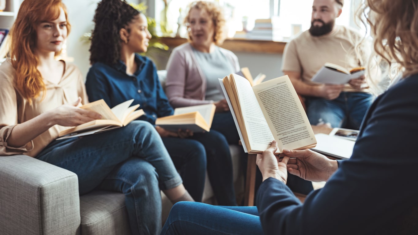 A group of coworkers reading together