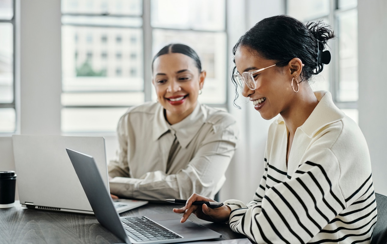 Business women working on a laptop, collaborating on a marketing strategy