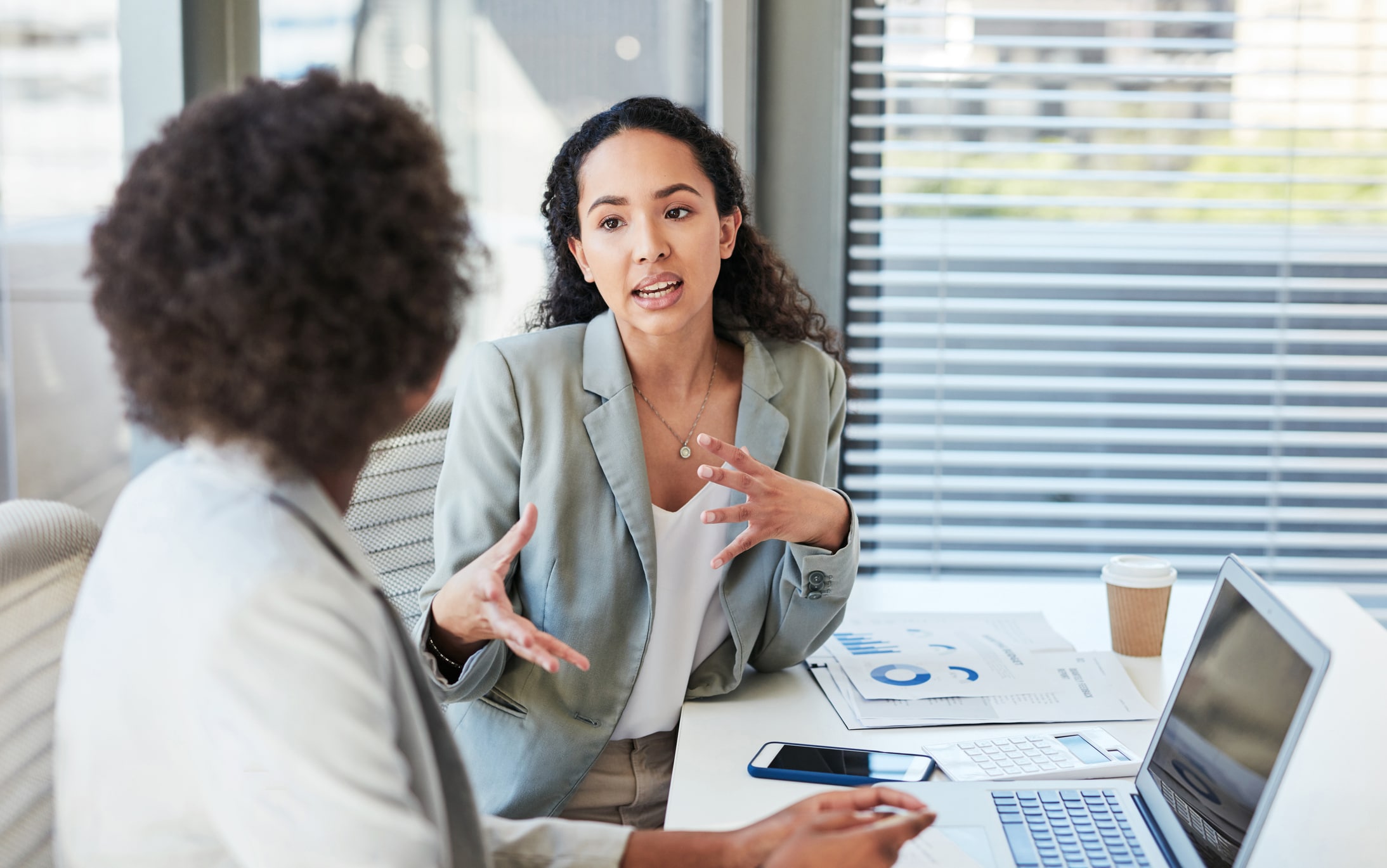 Two businesswomen having a discussion in an office