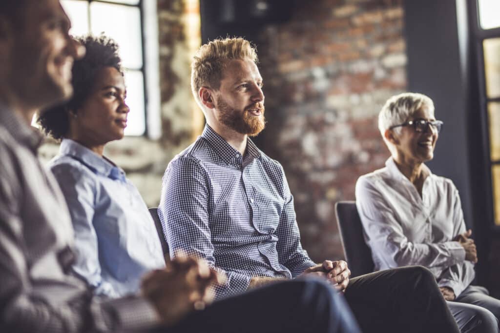 Business people sitting on an education event in a board room.