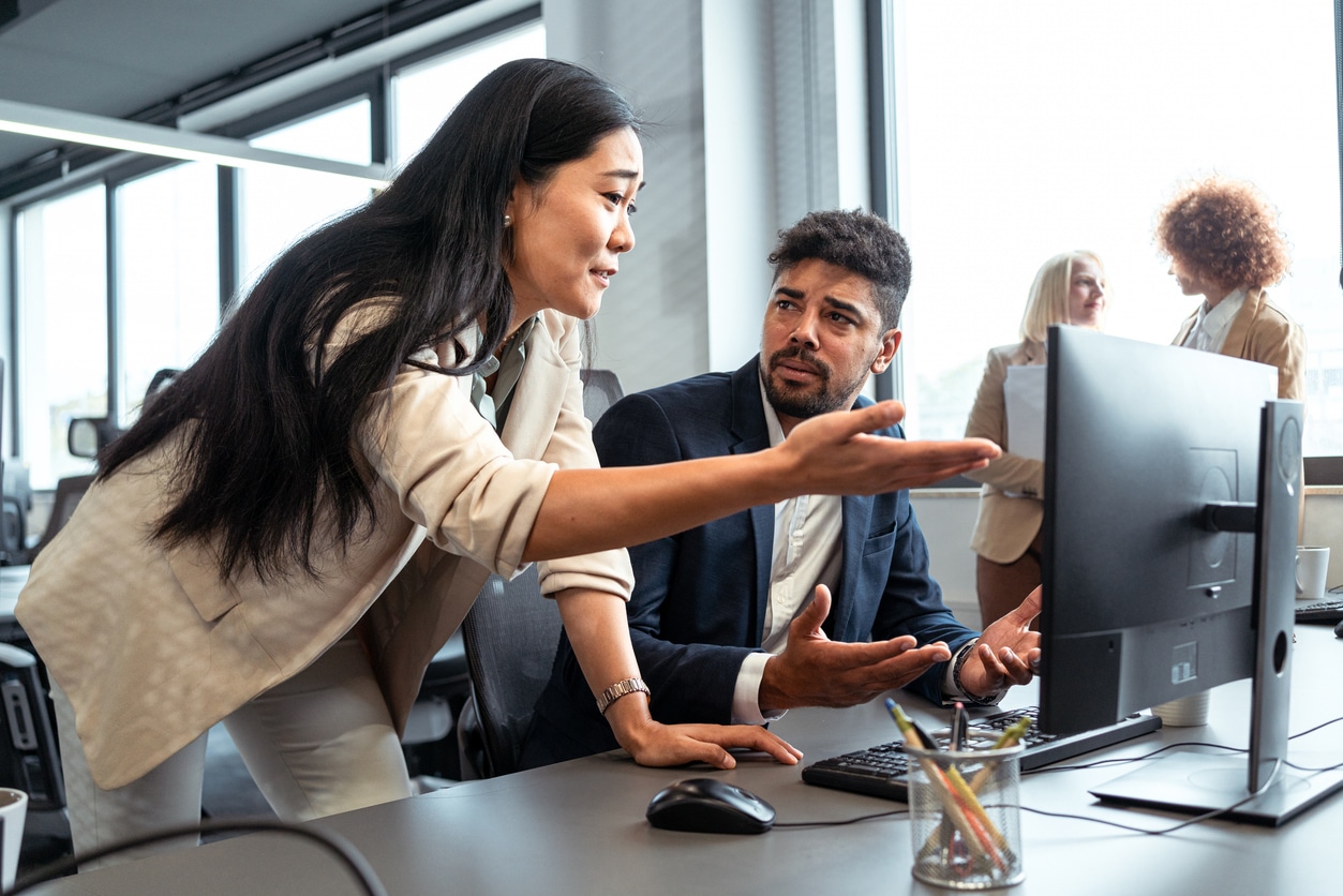 Disappointed businesswoman, arguing with her coworker in the office