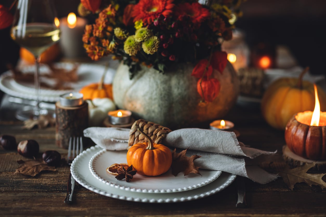 Fall table decoration with pumpkins, wine. Family cozy thanksgiving dinner arrangement indoors at home, wedding elegant decor. Countryside style, simple handmade setting, autumn mood, inspiration.